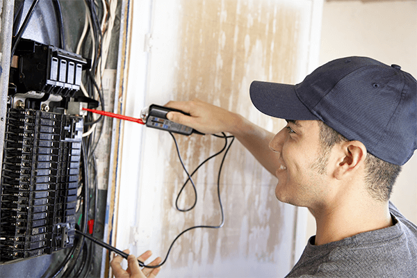 Electrician Working on Breaker Box in Kingman, KS