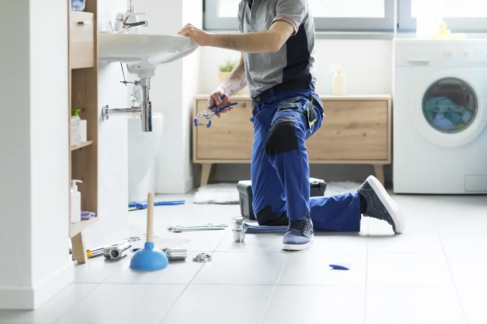 professional plumbing service. plumber in salina fixing a bathroom sink