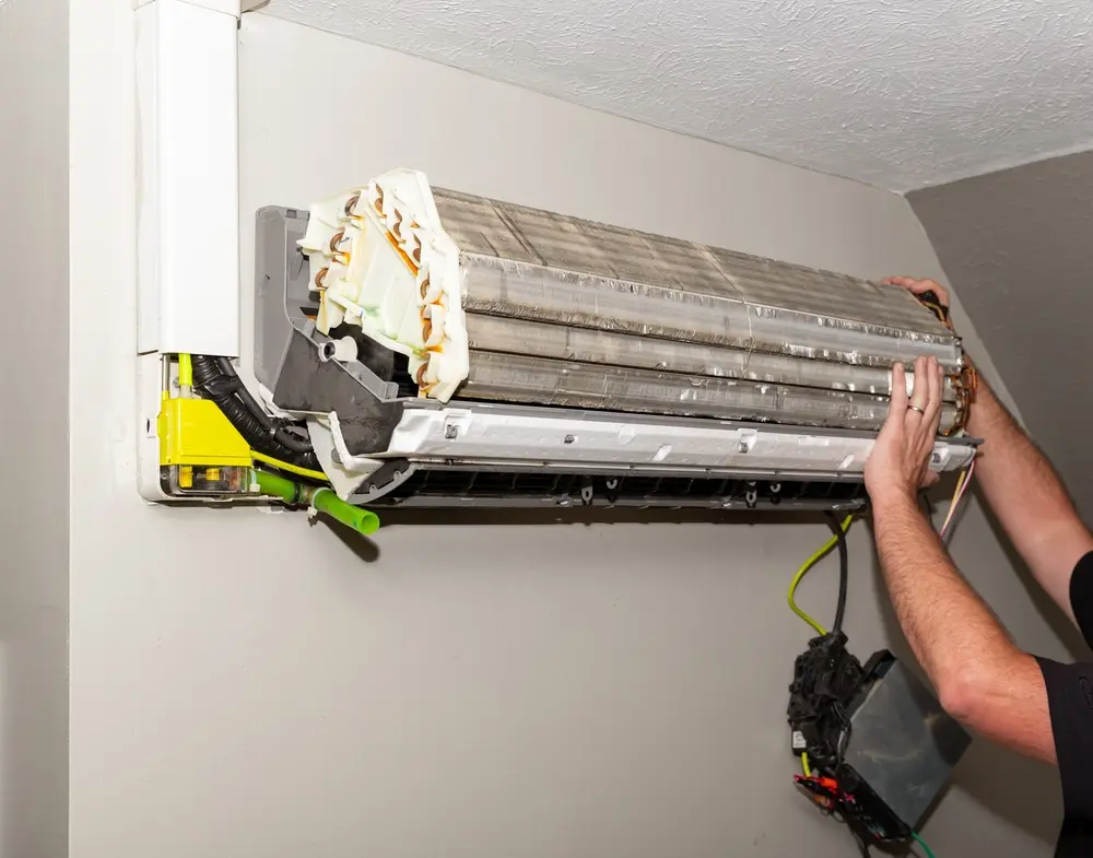 Repairman working on Air Conditioner ductless Mini-split system