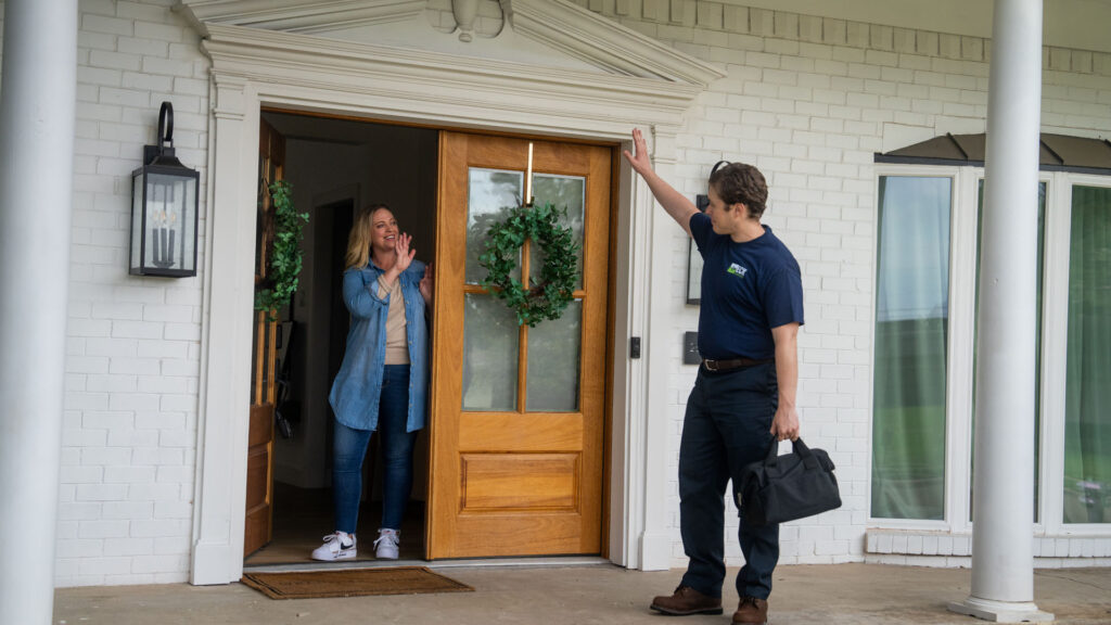 technician waving goodbye to customer
