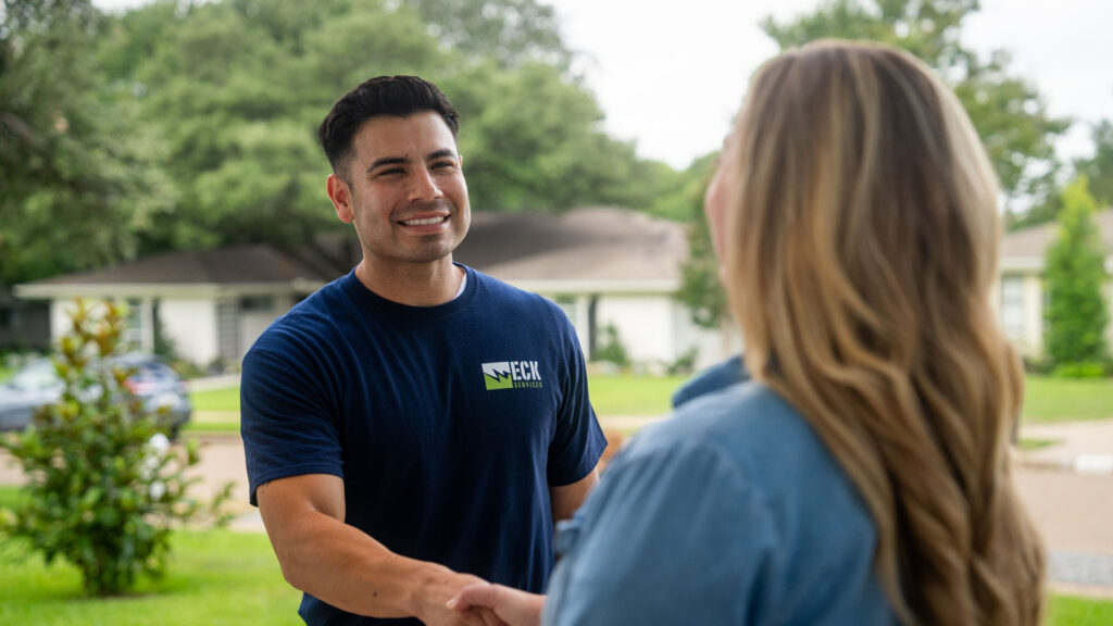 technician shaking hands with customer
