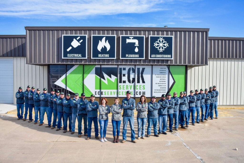 Team posing in front of building.